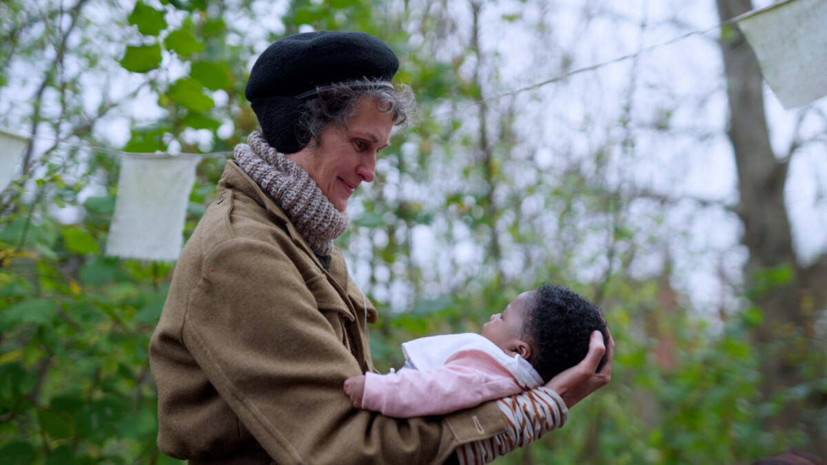 A volunteer holds a young baby as part of the Birth Partner Project.